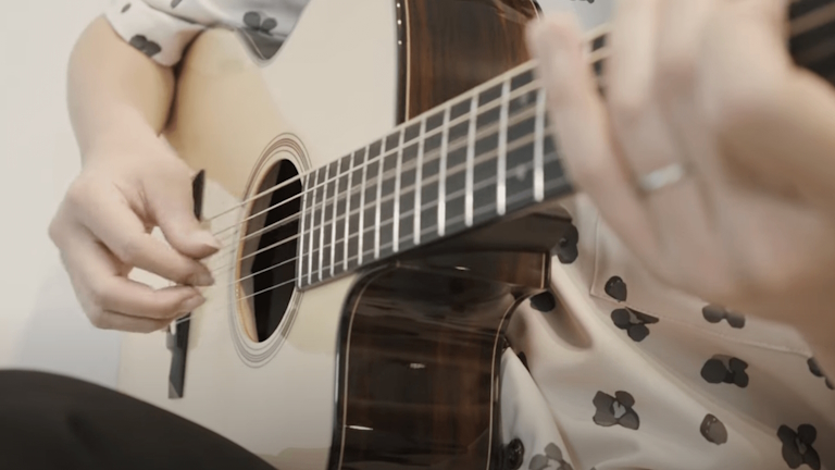 Fingerstyle guitarist Kenta Yago performs on a Bourgeois OMC Soloist.